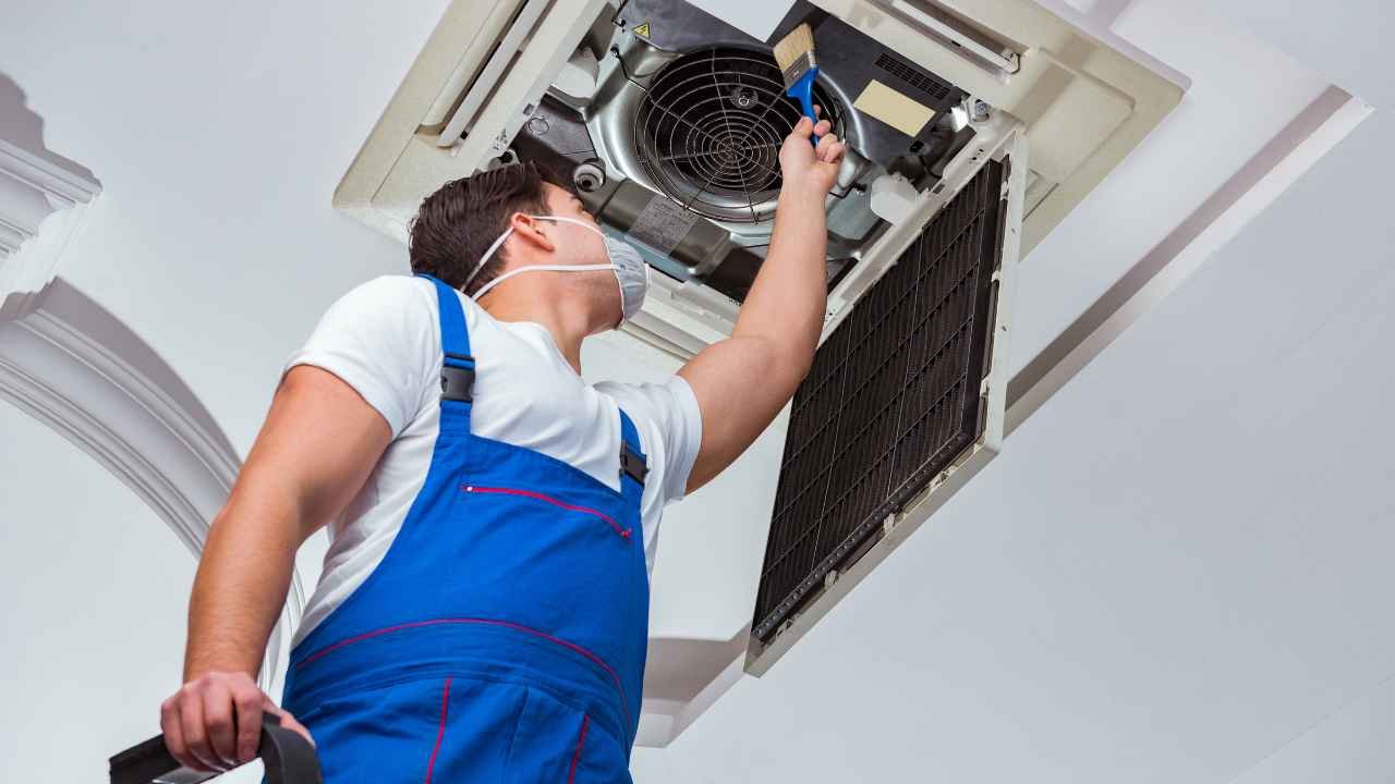 HVAC technician installing a central air conditioning system